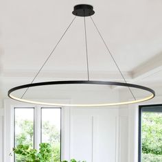 a large circular light fixture hanging over a dining room table