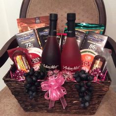 a basket filled with wine and chocolates