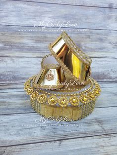 three gold wedding rings sitting on top of each other in front of a wooden background