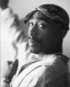 a black and white photo of a man with a turban on his head