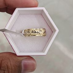 a person is holding a ring in their hand with a pair of scissors inside it