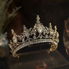 a gold tiara is displayed on a table