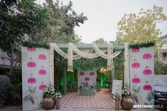 an outdoor wedding venue decorated with flowers and greenery