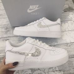 Authentic and Classic Nike Air Force One trainers beautifully hand embellished with genuine Swarvoski crystals on the Classic ticks. All the crystals are lovingly placed to ensure the maximum sparkle on this stunning style.  Available with two OR four ticks sparkled. Luxury Bedazzled White Sneakers, Bedazzled Air Force Ones, Zapatillas Nike Air Force, Teen Shoes, Bling Nike Shoes, Swarovski Nike, Nike Air Force One, Nike Air Force 1s, Custom Bling