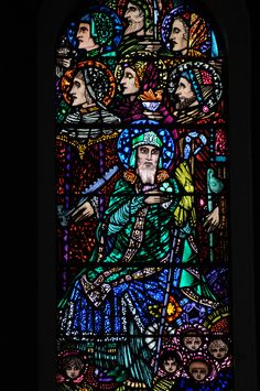 a stained glass window with many people in it