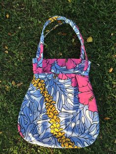 "From the Hawaiian Collection:  This purse is made with beautiful Hawaiian fabric of a lei, pink hibiscus flowers & monstera leaves. Interior is lined with a light pink fabric. Interior pocket is made with exterior Hawaiian fabric. This purse would make a great gift from the Islands or for yourself to commemorate your trip! Bag measurements are  15\" height by 13\" wide (at widest part)   Least widest part is 10\" wide (top) Interior pocket is 3 1/2\" tall by 10\" wide Straps are 26\" long. Mach Lei Purse, Trip Bag, Light Pink Fabric, Hawaiian Fabric, Pink Hibiscus, Kailua Kona, Monstera Leaves, Bag Measurements, Jan 20