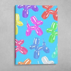 a colorful balloon dog pattern on a blue background is featured in this canvas art print