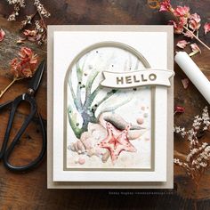 a close up of a card with scissors and flowers