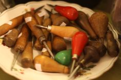 a white plate topped with lots of different types of toy kitchen utensils on top of a table