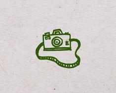 a camera with a cord attached to it sitting on a piece of paper that has been drawn onto