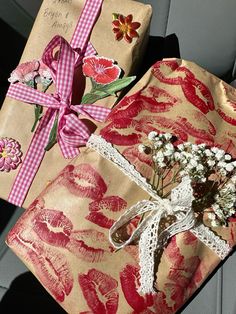 two wrapped presents sitting in the back seat of a car, tied with ribbon and decorated with flowers