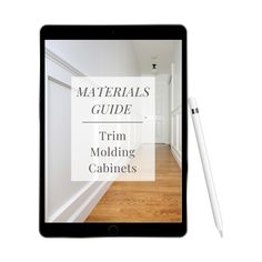 a tablet with the text materials guide trim molding cabinets on it next to a pen