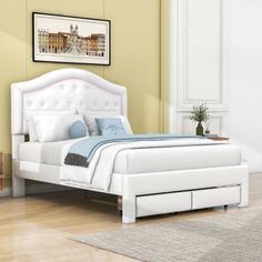 a white bed sitting on top of a wooden floor