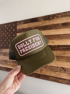 Olive green high crown foam trucker hat detailed with light pink Dolly for President graphic. Trendy Trucker Hats For Women, Trucker Hat Designs, Graphic Hats, Green Trucker Hat, Custom Trucker Hats