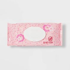 a pink tissue with a white circle in the middle and a bear on it's side