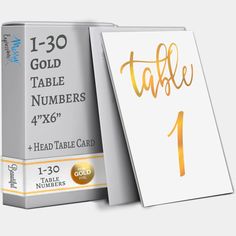 a table number card with gold foil lettering on the front and back of each card