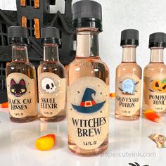 three bottles of witch's brew on a table