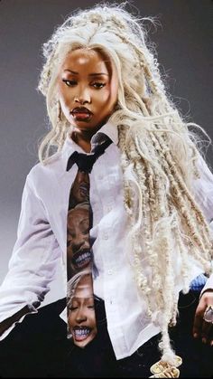 a woman with blonde dreadlocks sitting on top of a chair wearing a white shirt and tie