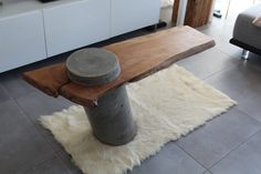 a wooden bench sitting on top of a white rug