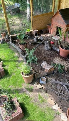 the garden is full of potted plants and other things to plant in it's back yard