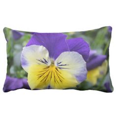 a purple and yellow pansy flower on a pillow