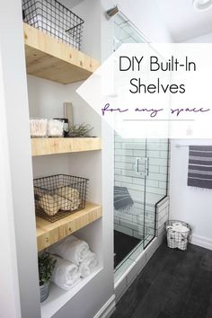 a walk in shower sitting next to a wooden shelf