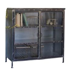 an old metal bookcase with glass doors and wicker baskets on the bottom shelf