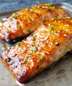 grilled salmon fillets with orange teriyan sauce and green onions on top