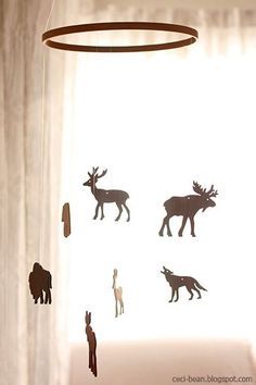 the silhouettes of animals are hanging from the ceiling