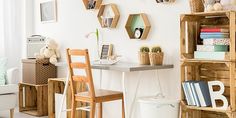 a living room filled with furniture and lots of books on top of wooden shelving