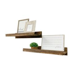 two wooden shelves with pictures on them, one has a potted plant and the other is