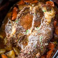 some meat and vegetables in a crock pot with broth on the side, ready to be eaten