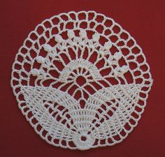 a crocheted doily on a red background