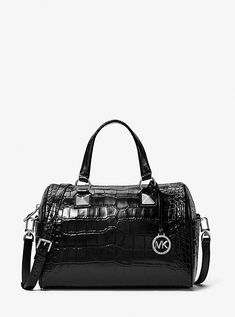 Our Grayson duffel is a glamorous finishing touch to any outfit. Crafted from crocodile-embossed patent leather, it’s topped with our charm and pyramid-stud accents for added shine. Top handles and an adjustable shoulder strap mean there are multiple ways to wear it. Michael Kors Black Double Handle Satchel, Michael Kors Satchel With Detachable Handle For On-the-go, Luxury Michael Kors Satchel With Silver-tone Hardware, Michael Kors Designer Shoulder Bag With Silver-tone Hardware, Michael Kors Leather Shoulder Bag With Silver-tone Hardware, Leather Billfold, Michael Kors Handbags, Michael Kors Satchel, Michael Kors Shoulder Bag