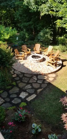 an outdoor fire pit surrounded by lawn chairs