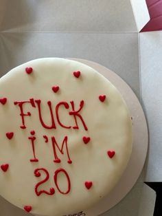 a white cake with red frosting that says f u k i m o on it