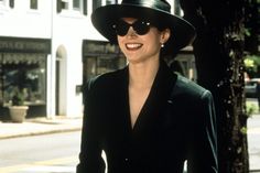 a woman wearing a black hat and sunglasses