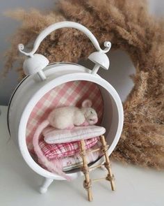 a stuffed animal is sitting in a small round shelf with clothes and blankets on it