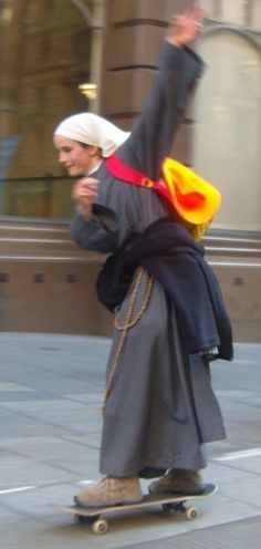 a man riding a skateboard down a street