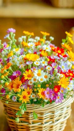 a basket filled with lots of colorful flowers