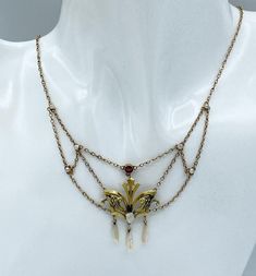 Lovely Art Nouveau 14k, garnet, seed pearl and freshwater pearl swag necklace. Marked 14k on clasp. Measures - 16 inches long, 40.64 cm Center measures - 4 x 1 1/2 inches, 10.16 x 3.81 cm Weight - 4.77 grams. CONDITION: Spring clasp is new. Otherwise in good vintage condition. If you like what you see here please take a moment to check out the other vintage jewelry I have for sale. I combine shipping costs for multiple purchases. Antique Art Nouveau 14k Garnet, Seed Pearl & Freshwater Pearl Swag Art Noveau Jewelry, Art Nouveau Necklace, Art Nouveau Jewelry Necklace, Art Nouveau Pearl Pendant Jewelry For Wedding, Vintage Necklace Antiques Boylerpf Antique & Vintage Jewelry, Art Nouveau Pendant Necklace, Art Nouveau Gold Necklace With Gemstone, Art Nouveau Necklace With Vintage Charm For Gifts, Luxury Art Nouveau Pearl Pendant Necklace