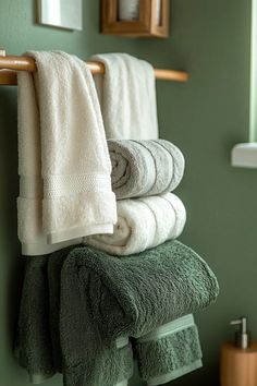 Bathroom with sage green walls and herringbone tile pattern sage green and blush accents visible