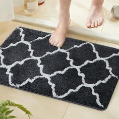 a person standing on a bath mat in the bathroom