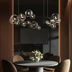 an elegant dining room with black walls and wooden paneling, round table surrounded by beige chairs