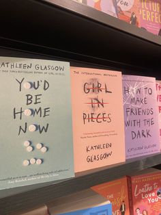 some books on a shelf in a store and one is pink, the other is blue