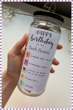 a person holding a jar with a happy birthday message on it