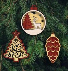 three wooden ornaments hanging from a christmas tree