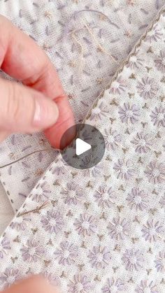 someone is stitching the fabric with scissors