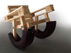 a wooden cart with two tires attached to it