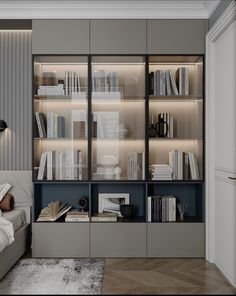 a bed sitting next to a book case filled with books on top of a wooden floor